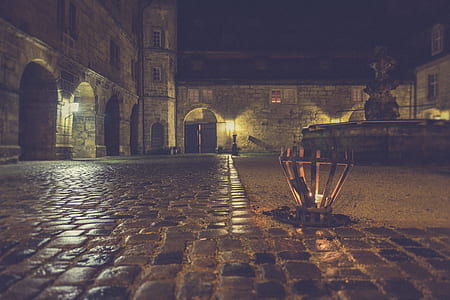 Brown Outdoor Lamp Beside Gray Stone Pavement during Nighttime thumbnail