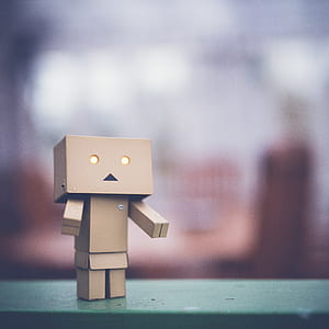 brown cardboard Danbo robot on green surface thumbnail