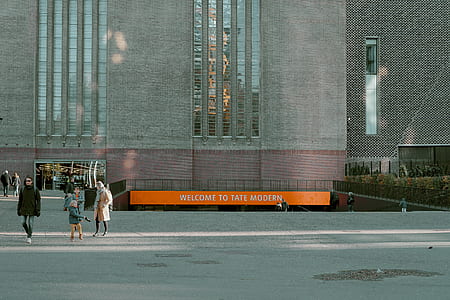 group of people walking near gray building thumbnail