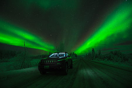 black Jeep Cherokee with northern lights thumbnail
