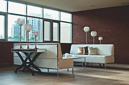 two white leather sofa on brown wooden parquet floor inside room thumbnail