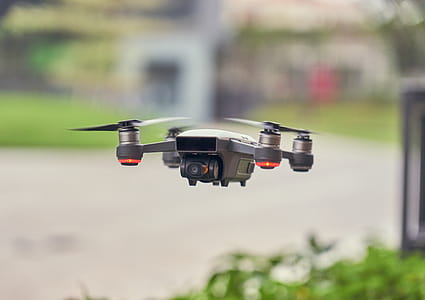 Selective Focus Photo of Flying Gray Quadcopter thumbnail