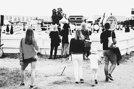 Grayscale Photo of People Gathering Near Clock thumbnail