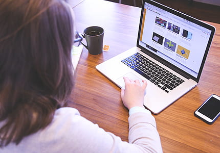 woman in front of turned on MacBook Pro thumbnail