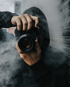 person using DLSR camera while facing the camera thumbnail