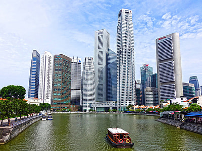 photo of white and red boat on river near on high rise building thumbnail