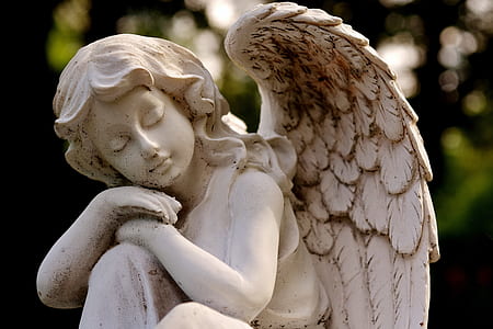 selective focus photography of angel statuette thumbnail
