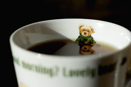 black liquid filled green and white ceramic cup thumbnail