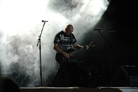 man playing guitar on stage thumbnail