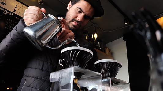 man holding kettle pouring grinder with water thumbnail