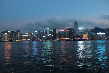 city buildings beside sea during night thumbnail