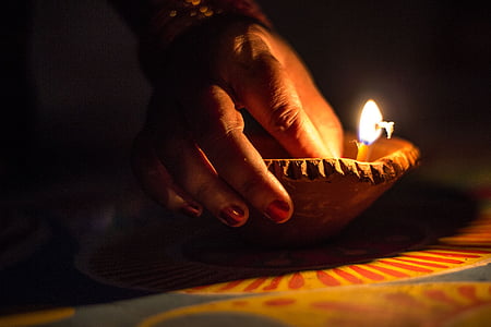 person holding pillar candle thumbnail