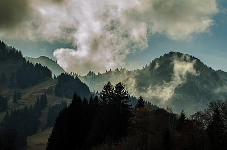 skyline photography of mountain under clouds during daytime thumbnail