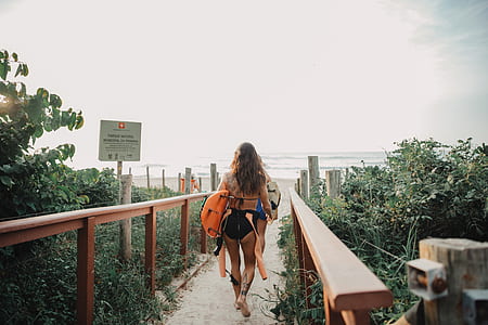 woman in black walking and going to the sea thumbnail