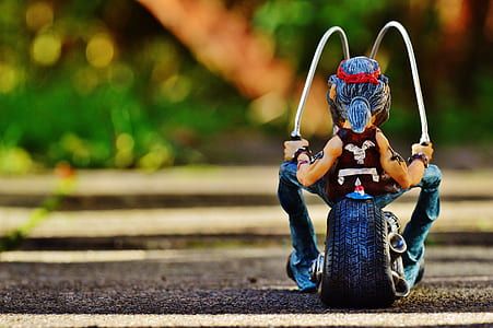 selective focus photography of man riding on motorcycle figurine thumbnail