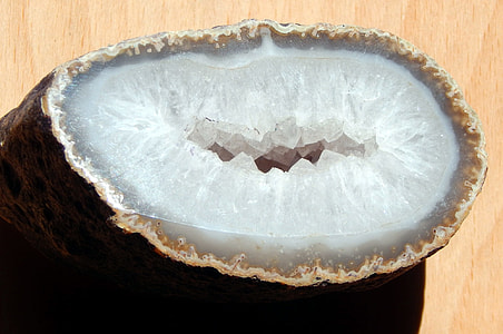 photo of white and brown geode on wooden board thumbnail
