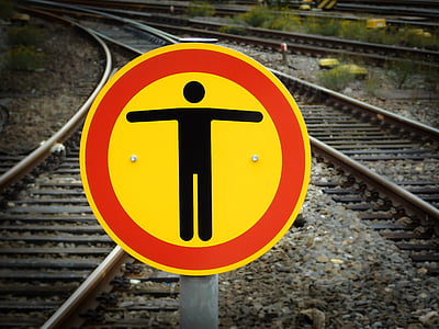 yellow and red metal train signage at daytime thumbnail