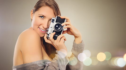 woman doing pose and using camera thumbnail