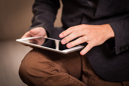 person holding tablet computer thumbnail