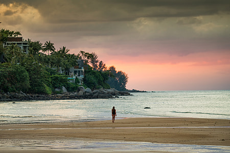person standing on seashore during day time thumbnail