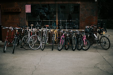 assorted bikes parked on road during daytime thumbnail