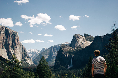 man staring at the mountain range during daytime thumbnail
