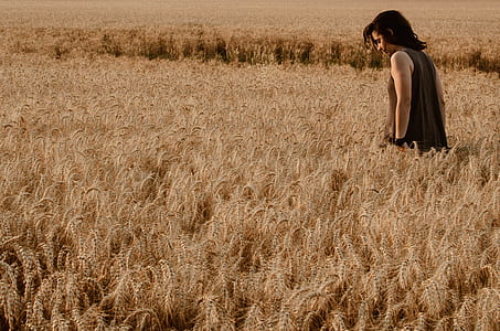 man in black tank top surrounded by grass thumbnail