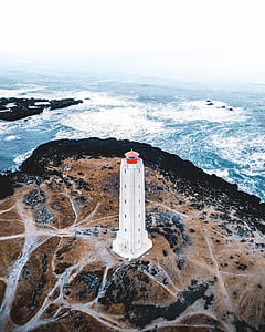 aerial view of white lighthouse during daytime thumbnail