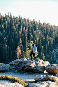 man standing on gray stone during daytime thumbnail