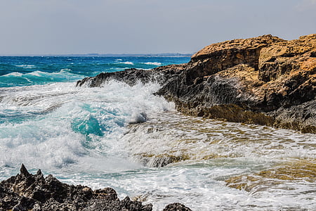 sea waves and brown rock formation thumbnail