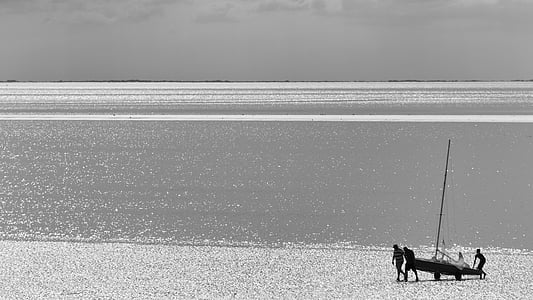 grayscale photography of four person carrying boat thumbnail
