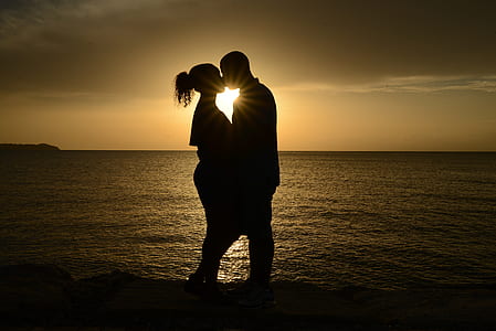 silhouette of couple kissing during golden hour thumbnail