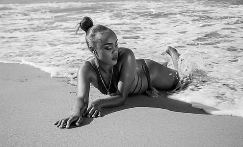 woman lying on beach sand thumbnail