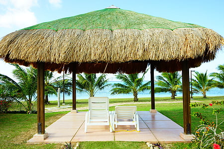 two white plastic loungers near sea thumbnail