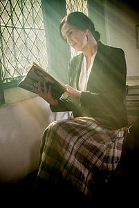 woman wearing black formal coat reading book thumbnail