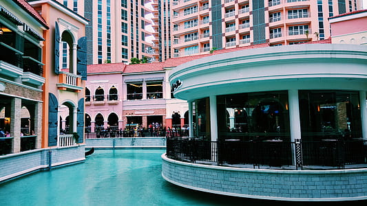 pink and white concrete building with pool thumbnail