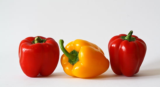 macro shot of two red and one yellow bellpeppers thumbnail