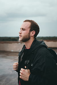 man standing on road with backpack thumbnail