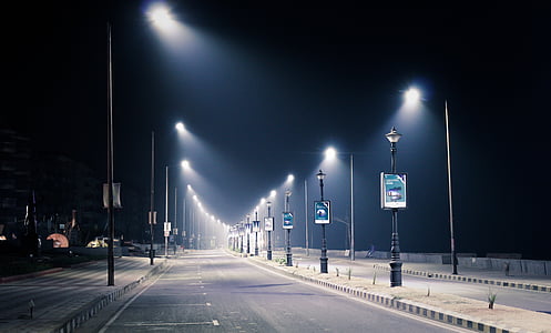 roadside parking lot with streetlamps during nighttime thumbnail
