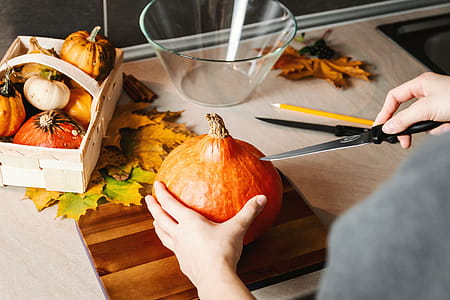 Girls hands carve the pumpkin. Halloween. thumbnail