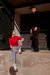 woman sitting beside man standing thumbnail
