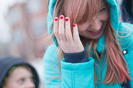 Woman Covering Her Face While Smiling thumbnail