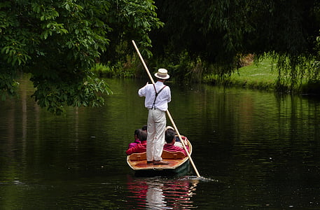 man rowing on boat with passengers sitting thumbnail