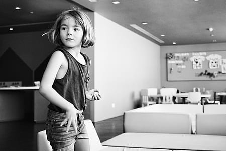 grayscale photography of girl standing inside the room thumbnail