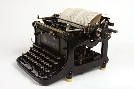 black typewriter with printer paper thumbnail