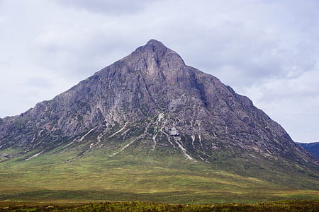 black and green mountain under cloudy sky thumbnail