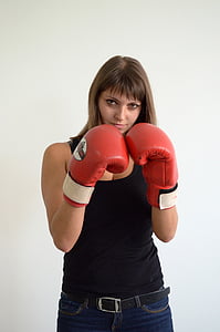 woman standing while wearing red boxing gloves near wall thumbnail
