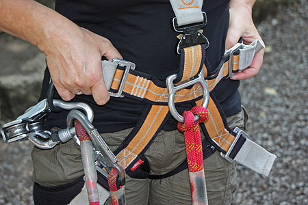 person standing holding body harness thumbnail