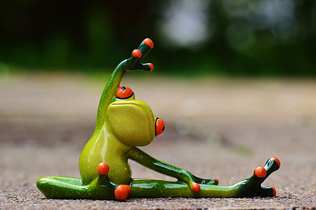 green ceramic frog holding knee during daytime thumbnail