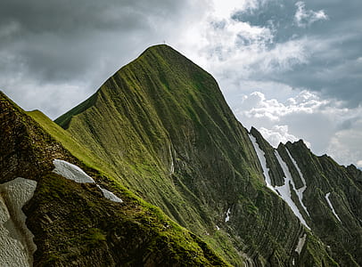 photo of rock formations under white clouds at daytime thumbnail